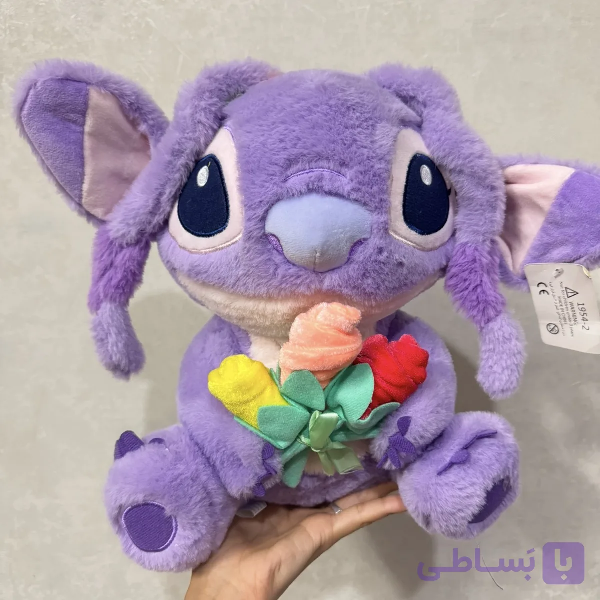 عروسک استیج بنفش گل به دست💜