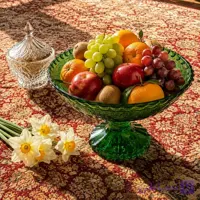 «ظرف میوه‌خوری شیشه‌ای سبز پایه‌دار»