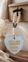 آویز سرامیکی قلبی «HOME SWEET HOME» با مهره‌های چوبی و چشم‌زخم