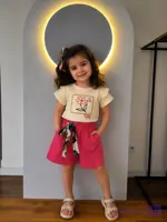ست دخترونه ۳ سال شامل تیشرت کرم با گلدوزی گل و شلوارک صورتی