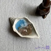 شمع دست‌ساز دریایی مدل حلزونی (طراحی ساحلی در صدف سرامیکی)